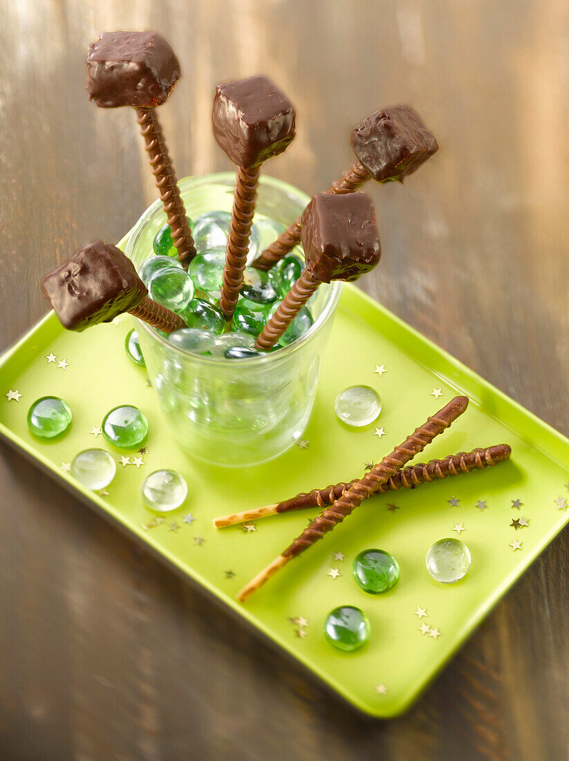 Chocolate coated marshmallows on toffee Mikado sticks