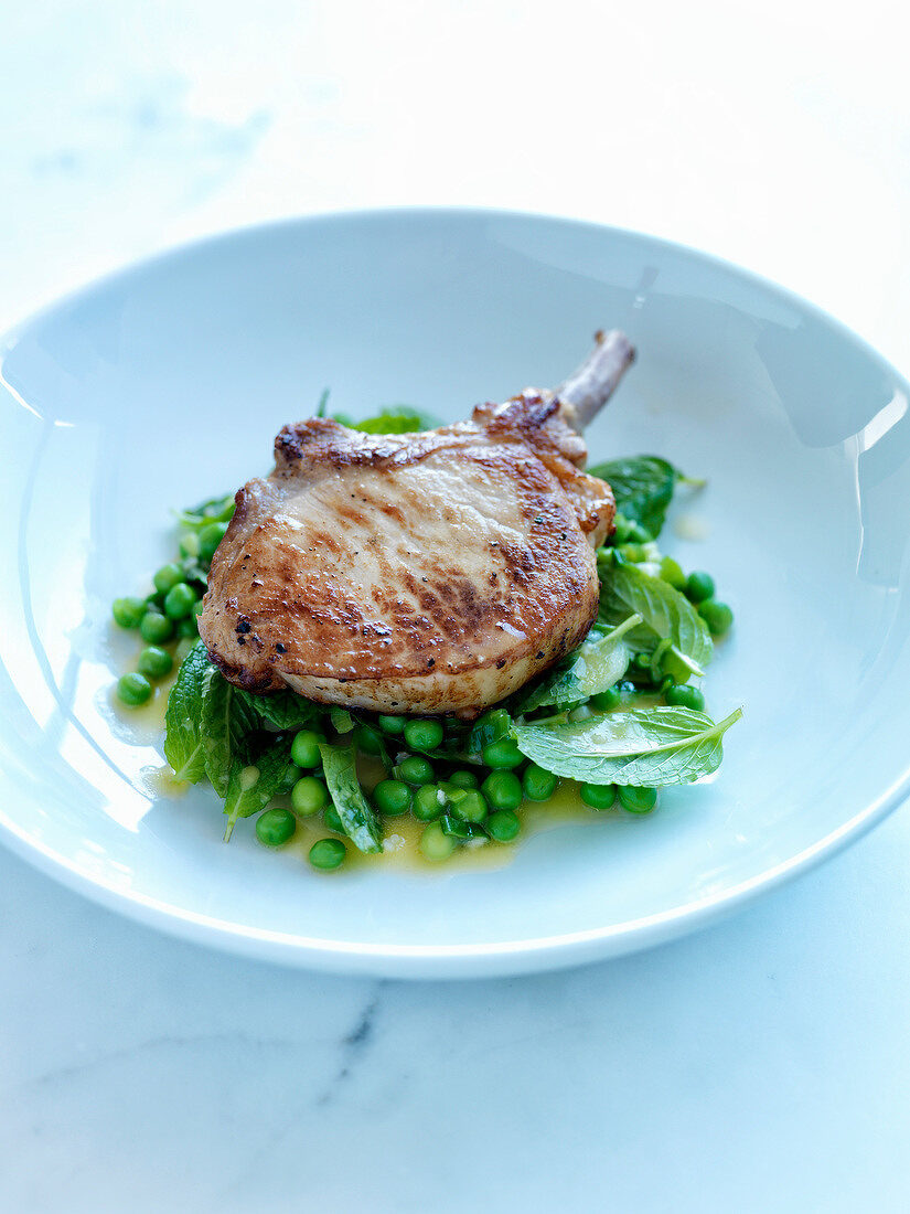 Grilled pork chop with minty peas