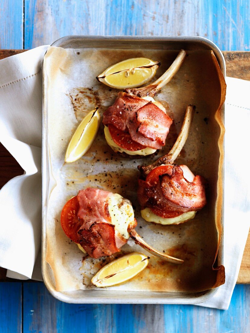 Lamb chops wrapped in cheese, tomatoes and bacon