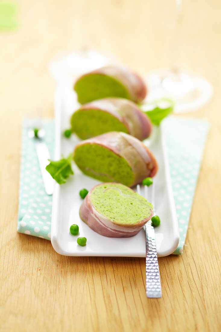 Pea mousse and raw ham sliced roll