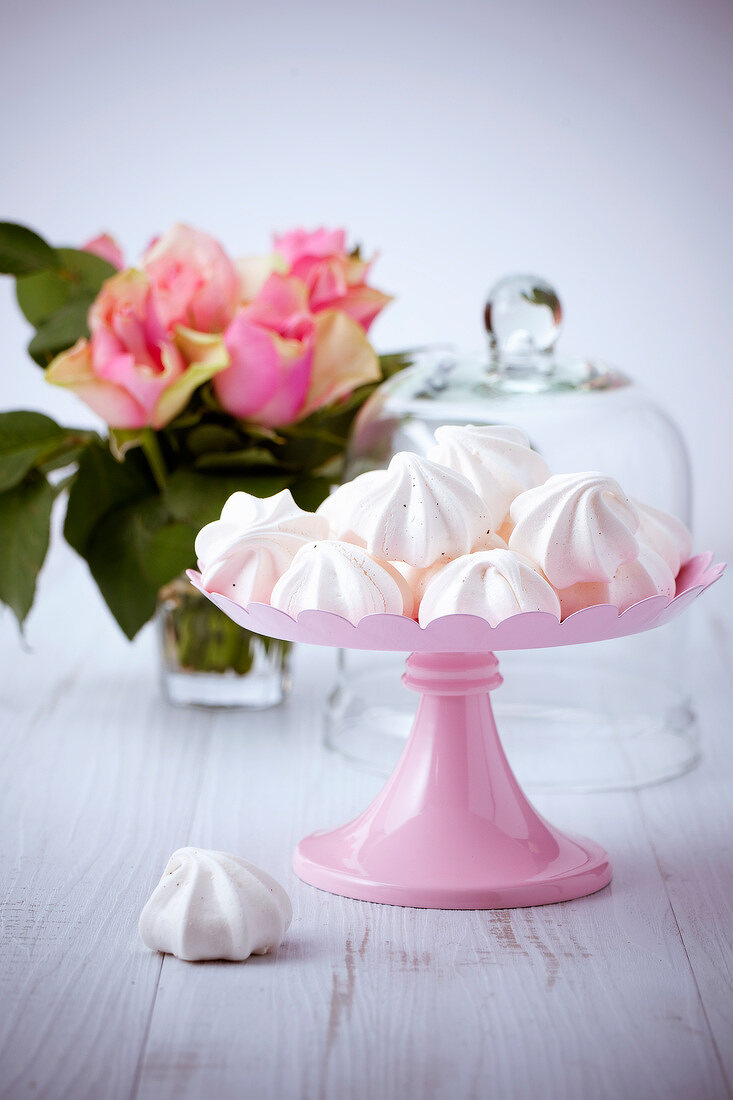 Meringues on pink pastry stand