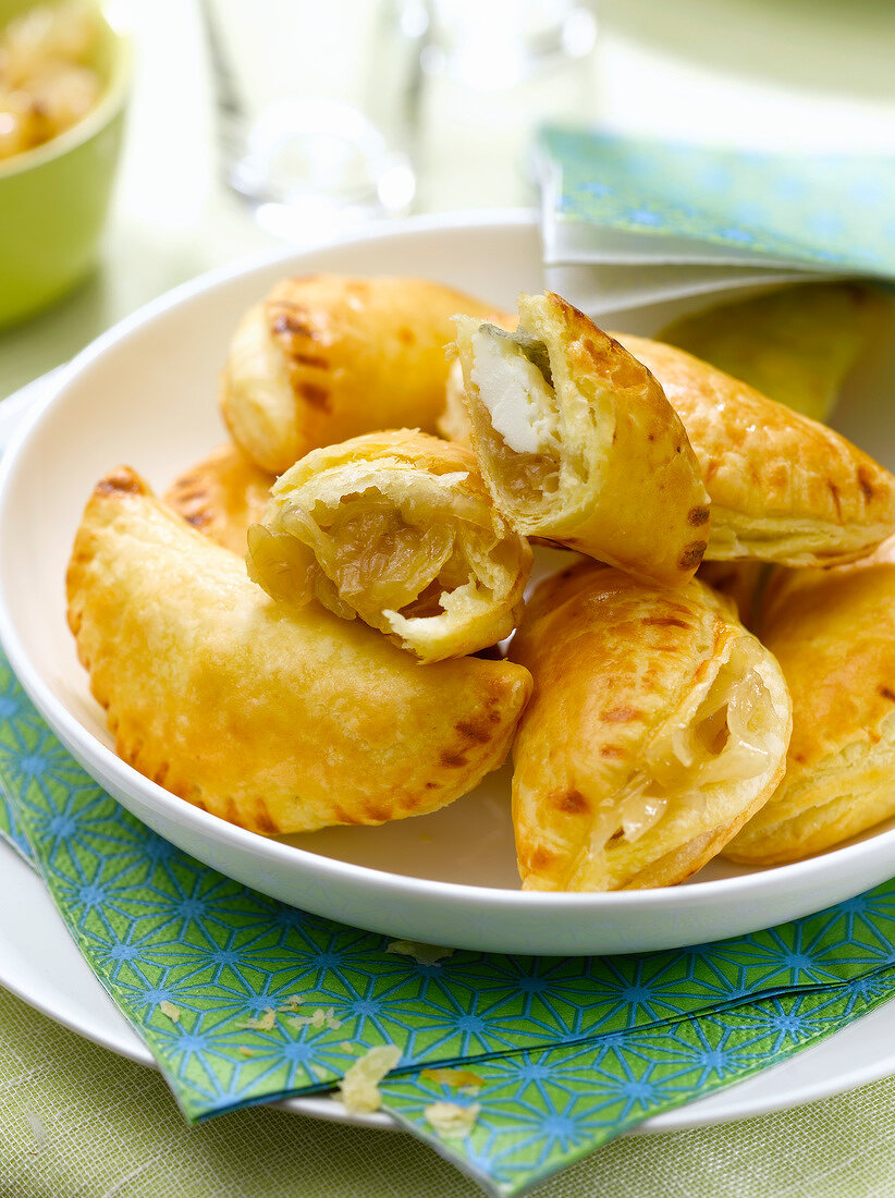 Small goat's cheese and stewed onion turnovers