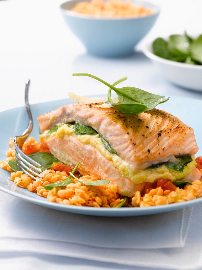 Roasted salmon stuffed with spinach, orange lentils cooked with coconut milk