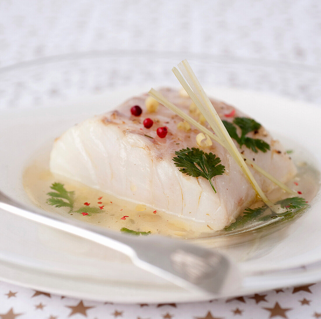 Piece of cod in a coriander and citronella-flavored broth