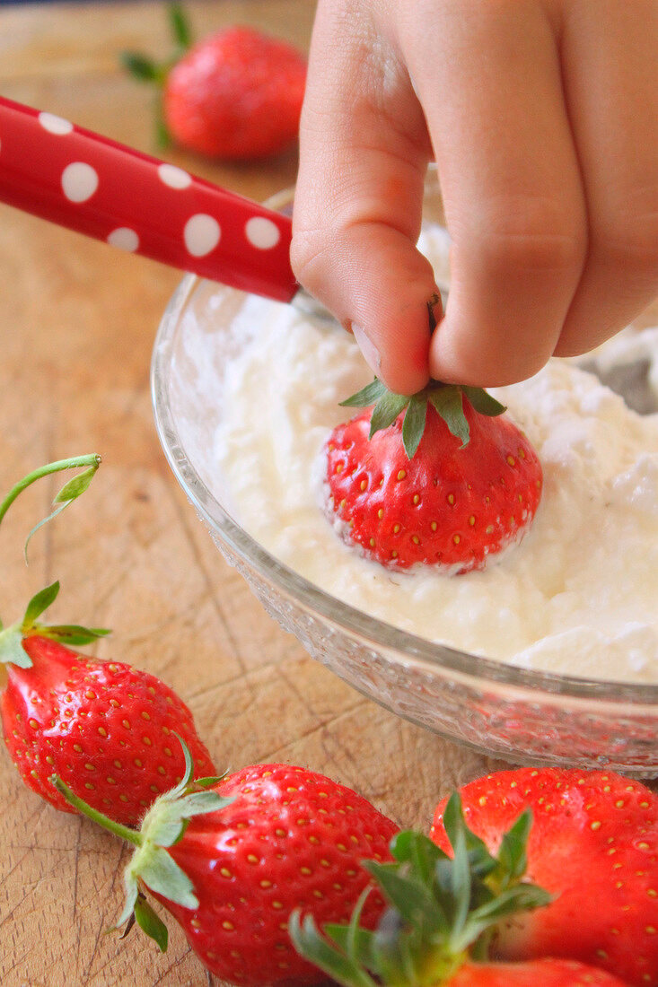 Dipping a strawberry in whipped Fromage blanc