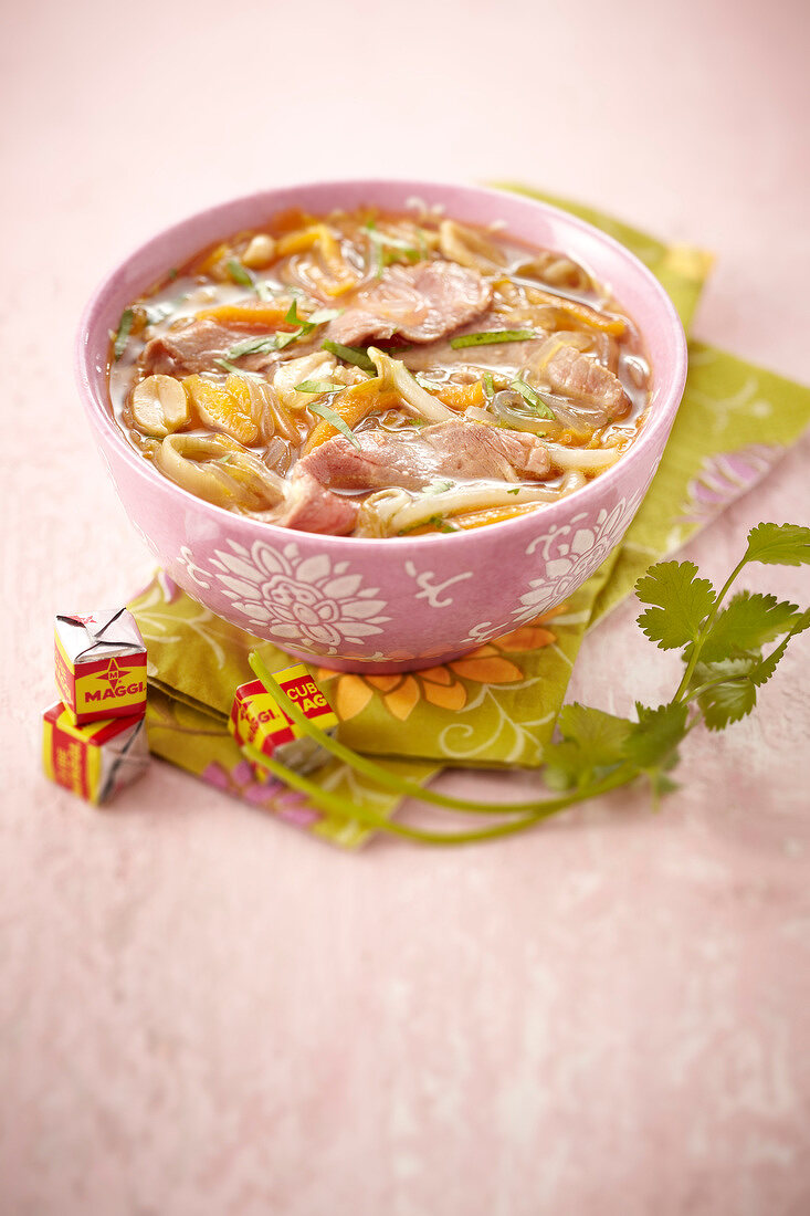 Maggi stock cube and thinly sliced pork broth