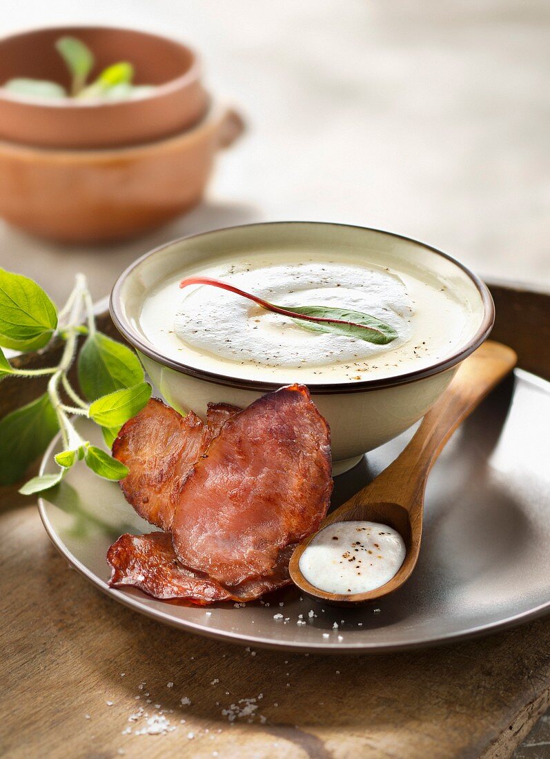 Cream of potato soup with smoked streaky bacon foam and crisp bacon slices
