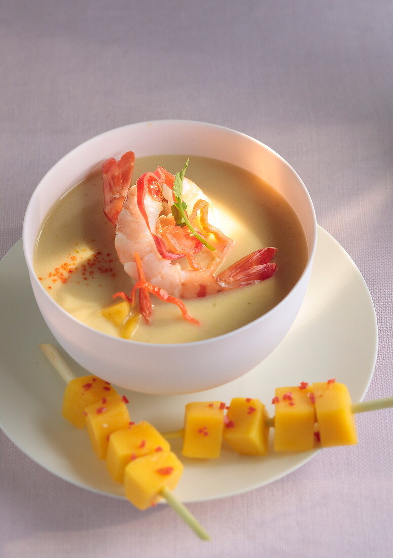 Cream of coconut soup with shrimps and mango