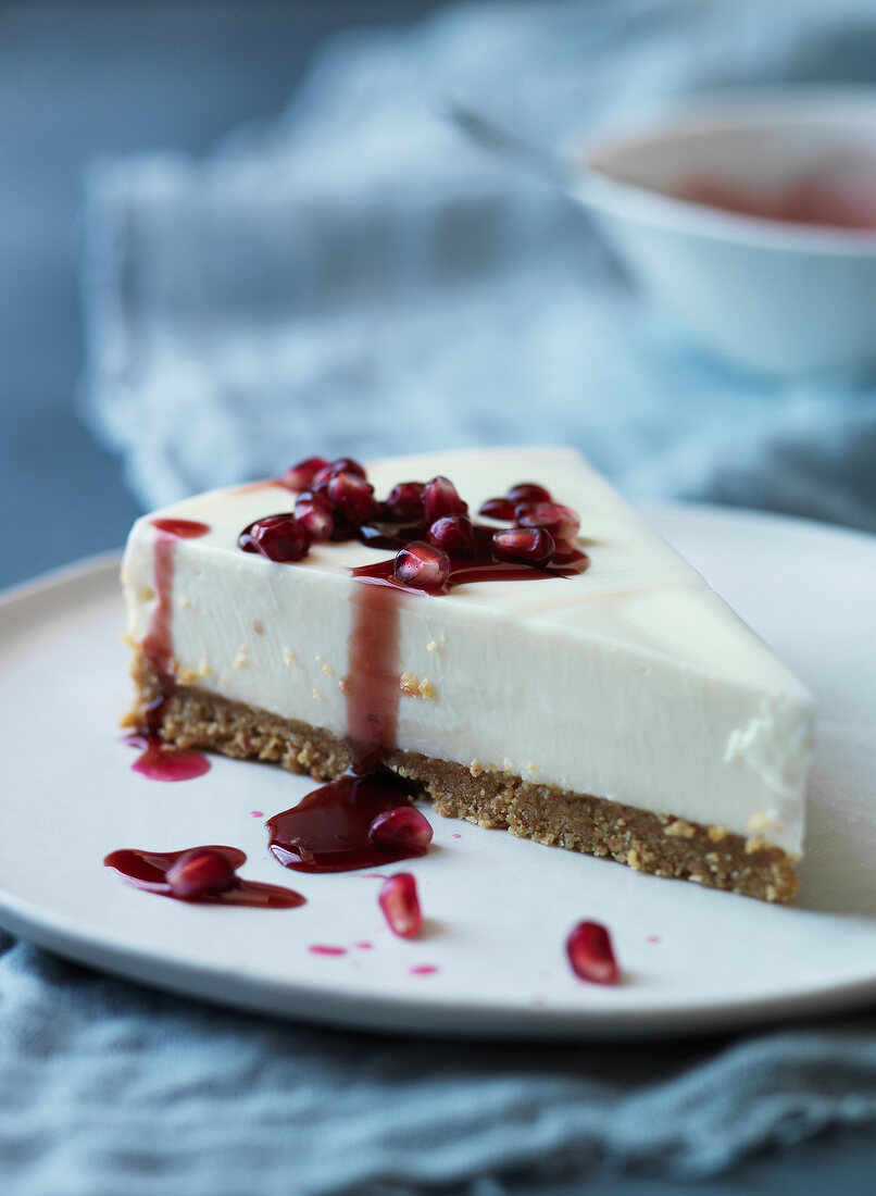 Slice of cheesecake with pomegranate sauce