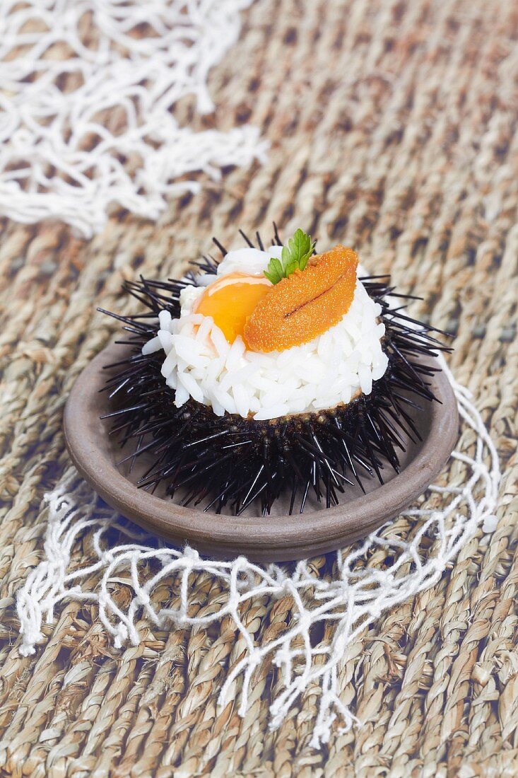 Rice with urchin roe and quail's egg served in and urchin