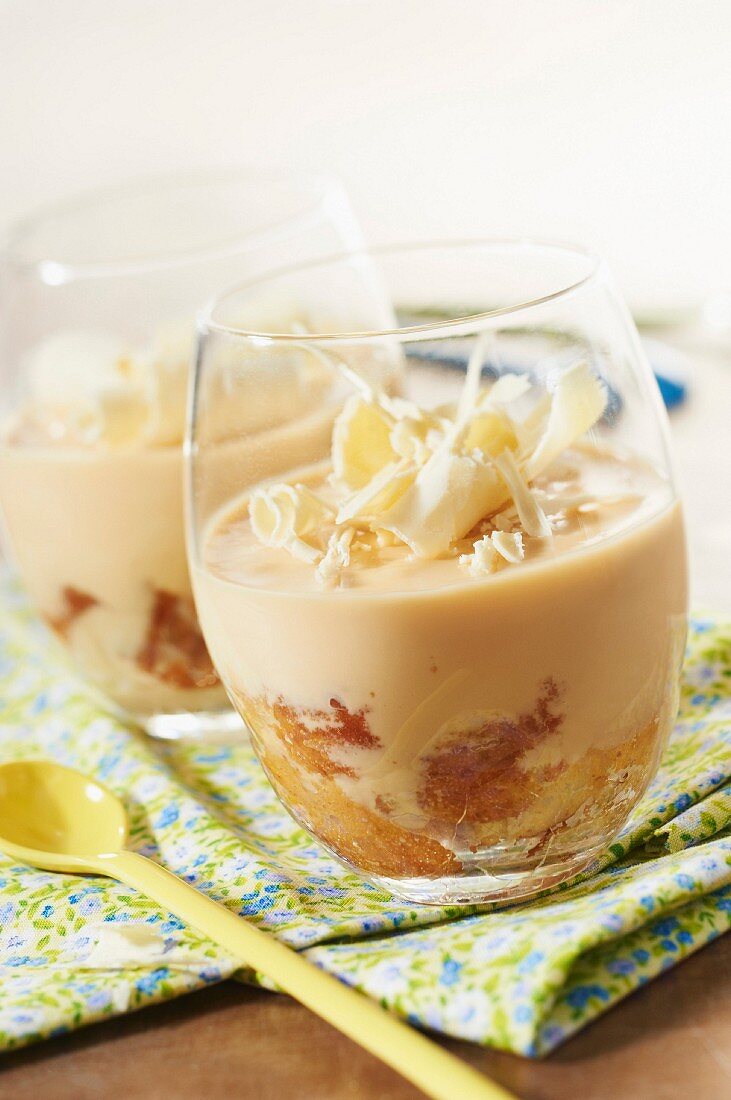 Almond-flavored coffee cream dessert with white chocolate flakes