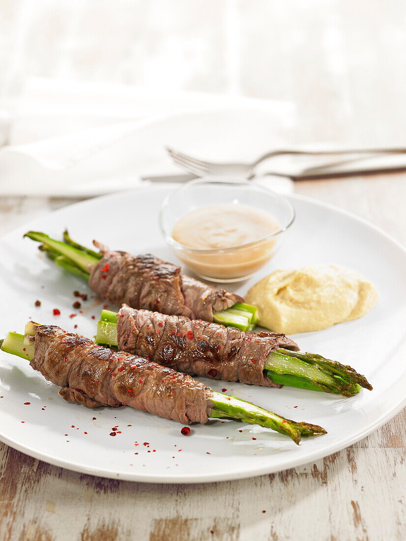 Green asparagus wrapped with thinly sliced veal