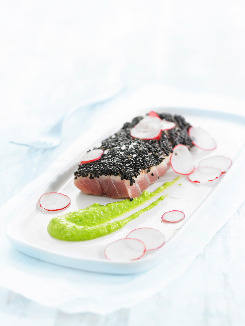 Tuna Ventrèche in a black sesame crust, thinly sliced radishes and wasabi sauce