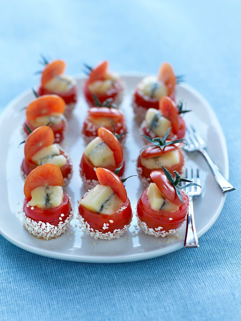 Cherry tomatoes stuffed with Morbier and coated with sesame seeds