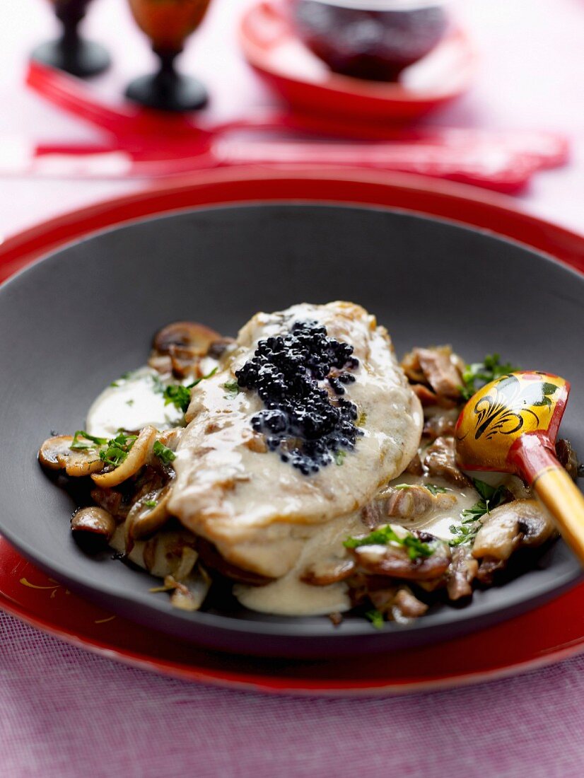 Chicken escalope in creamy mushroom sauce and topped with caviar