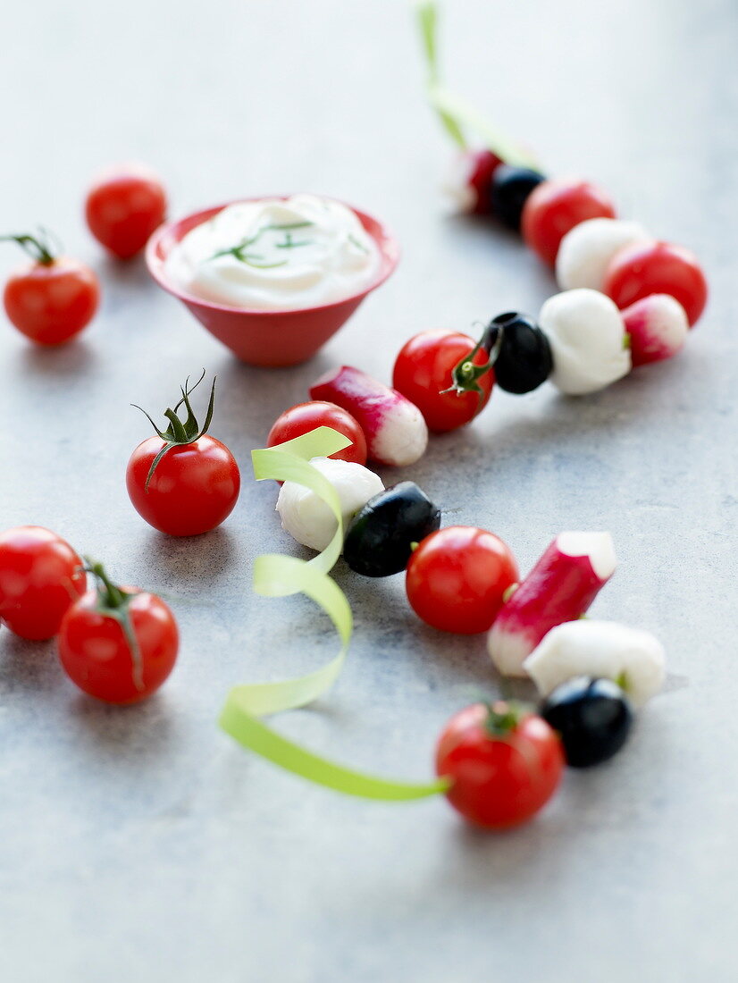 Stringed vegetables and mozzarella balls and dip