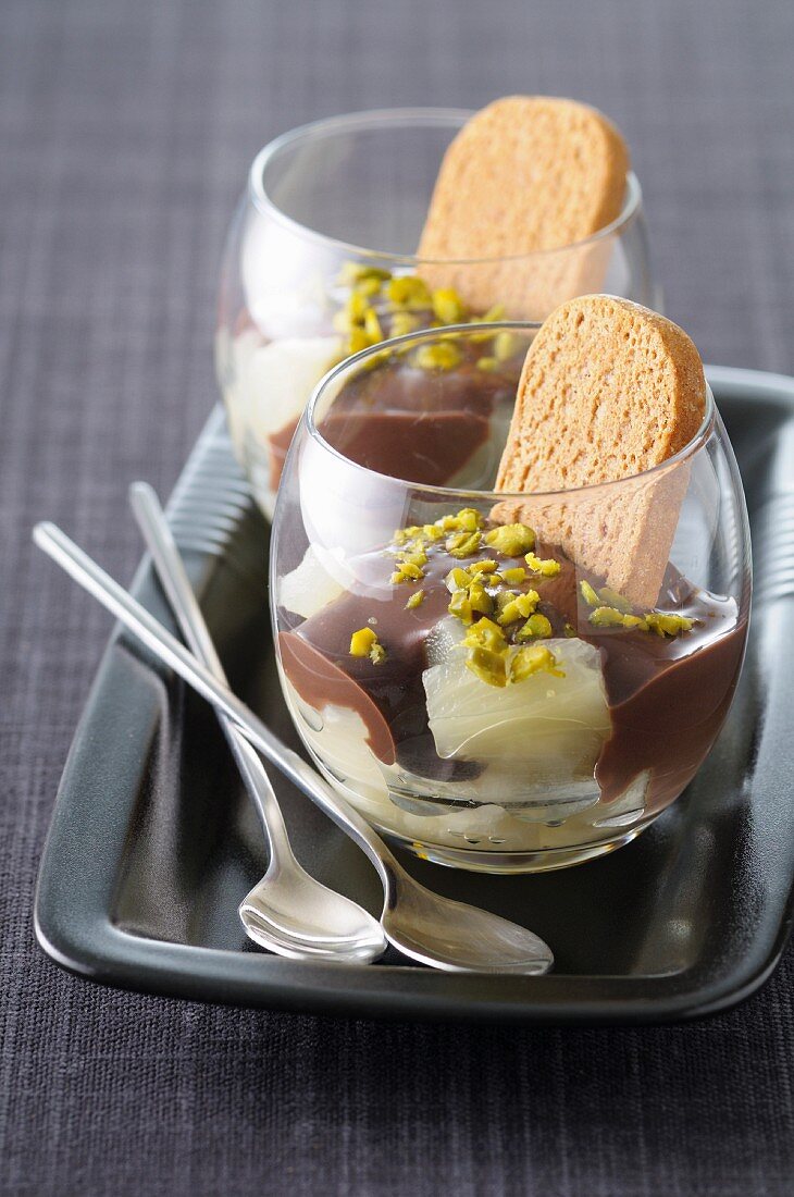 Fresh pineapple with melted chocolate and crushed pistachios,Speculos ginger biscuits