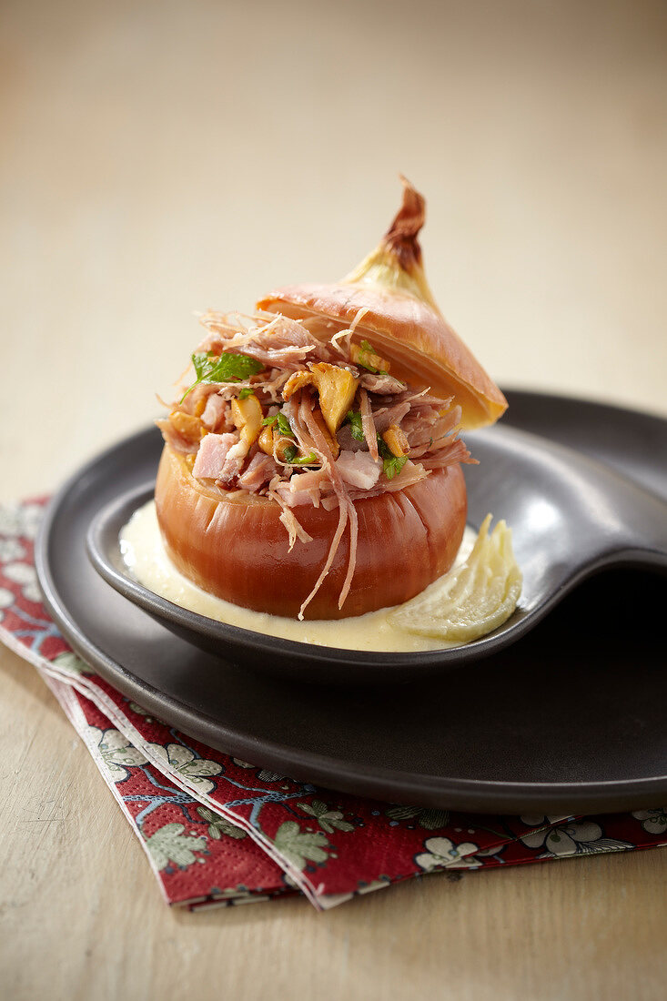 Onion stuffed with duck confit and chanterelles