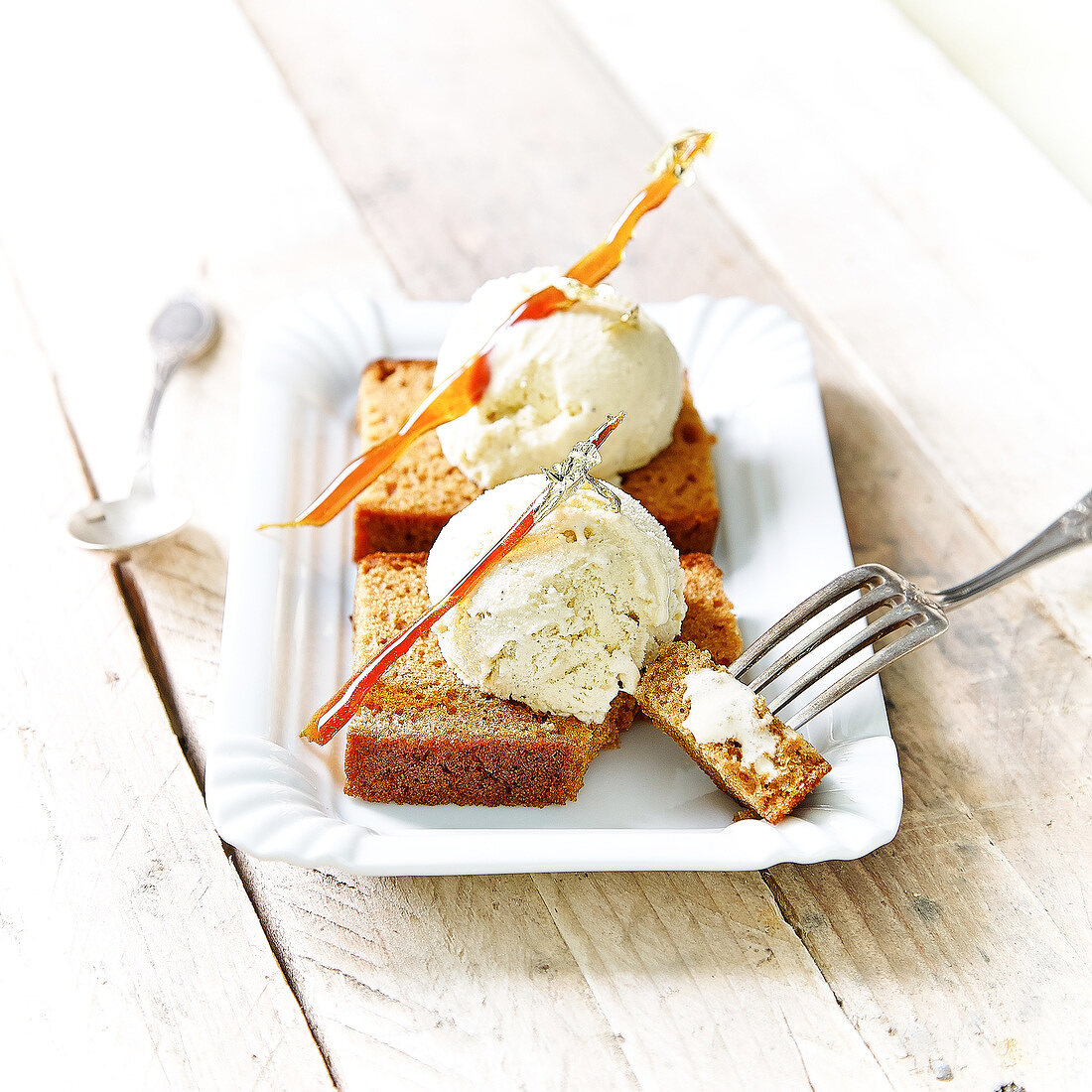 Vanilla ice cream on sliced gingerbread and topped with caramel sticks