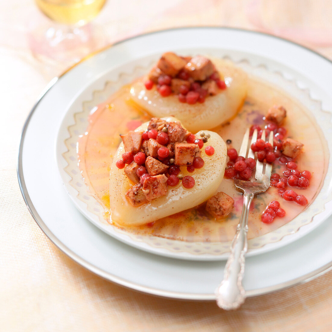 Pears garnished with foie gras and cranberries