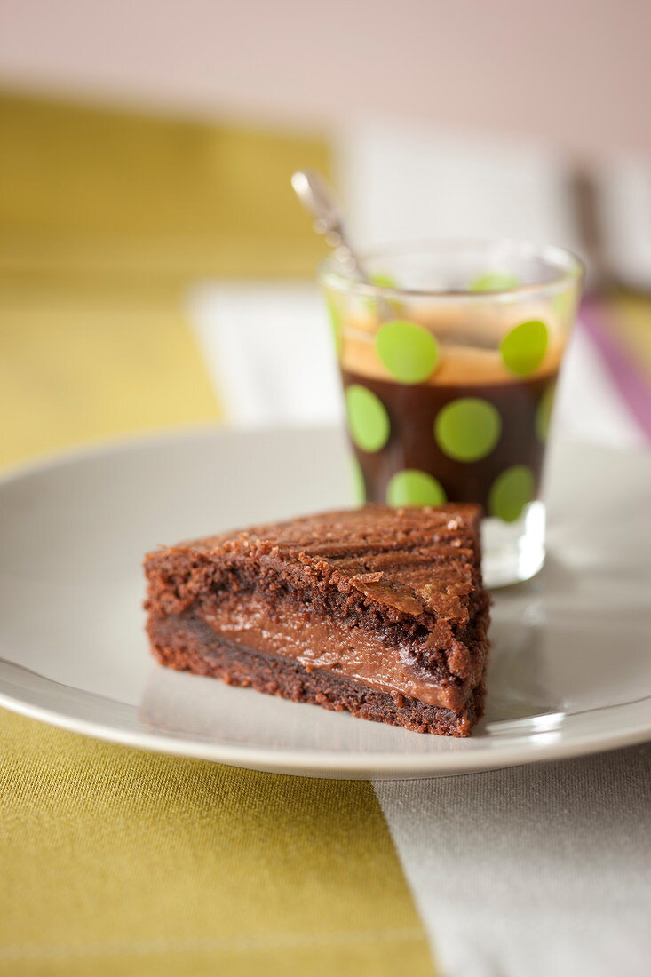 Slice of revisited chocolate Basque cake and an expresso