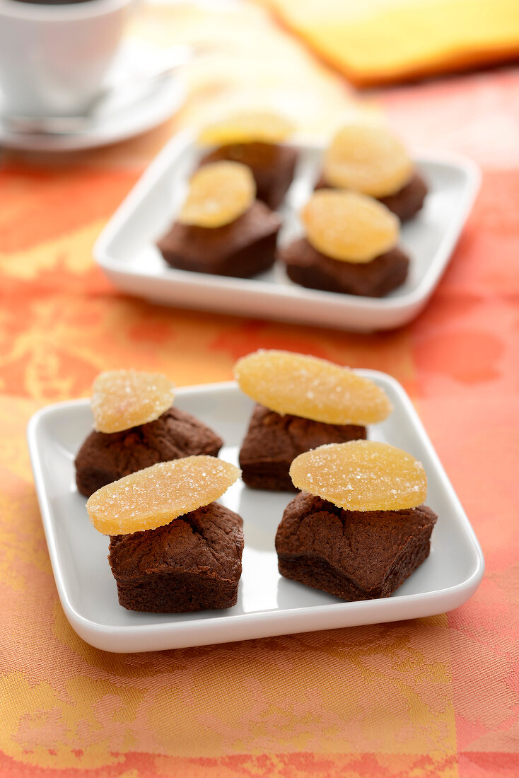 Squares of soft chocolate cake topped with crystallized ginger