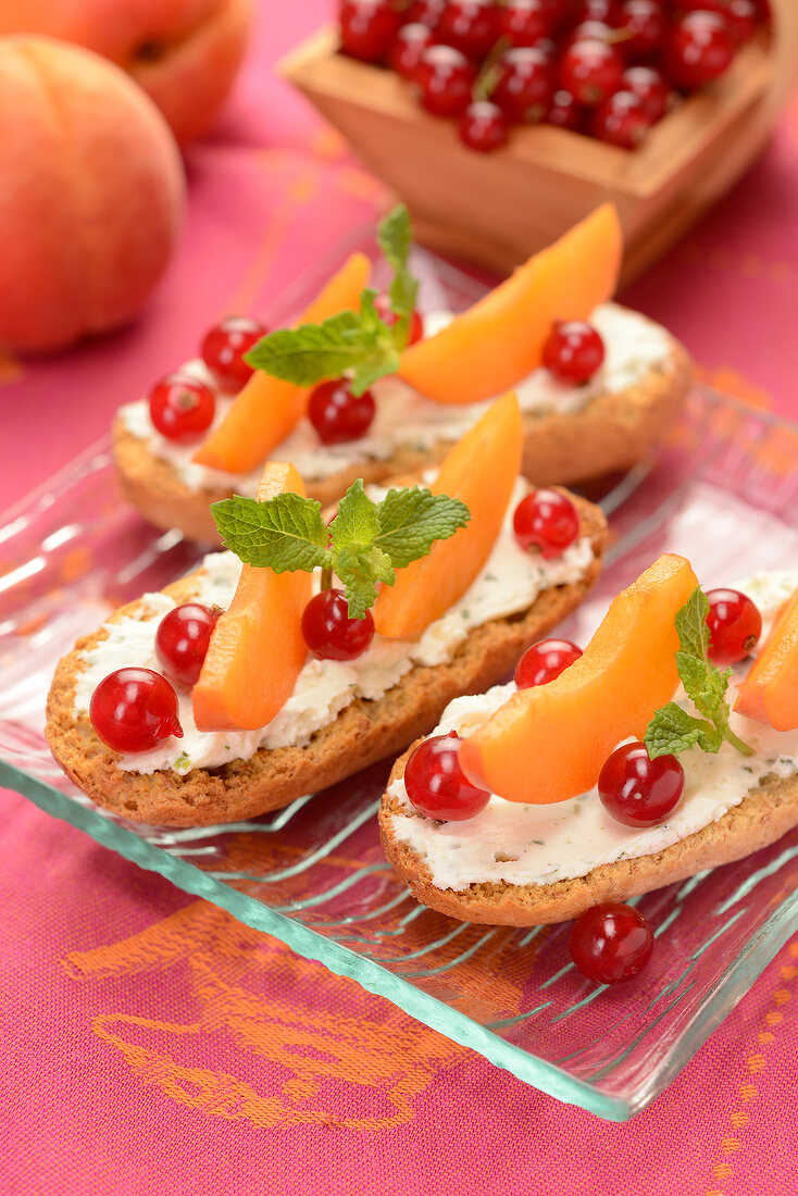 Krisprolls dry bread with cream cheese, redcurrants, apricots and mint