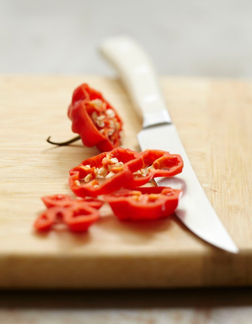 Thinly slicing a hot red pepper