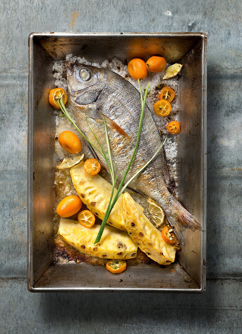 Oven-baked sea bream with pineapple and kumquats