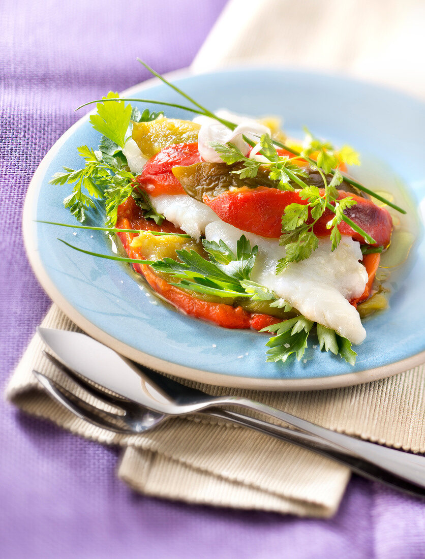 Layered halibut,peppers and fresh herbs with roasted pink garlic