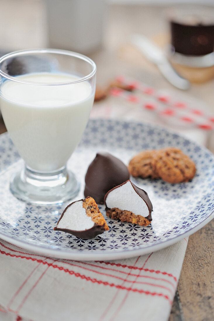 Chocolate and meringue drops and a glass of milk