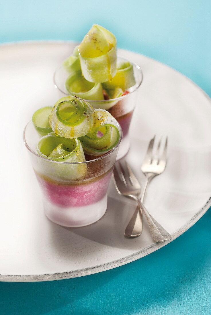 Goat's cheese and beetroot ice cream topped with thinly sliced cucumber rolls