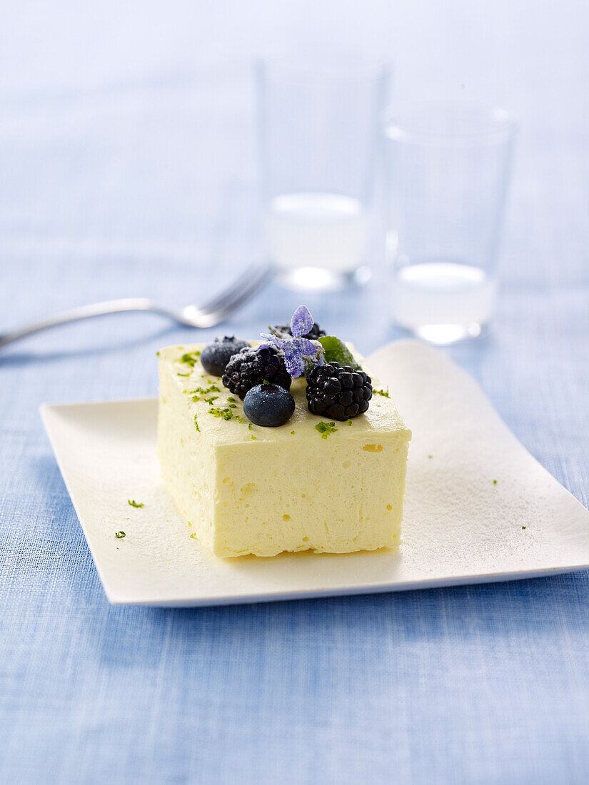 Small Parfaits topped with blackberries,blueberries and crystallized borage