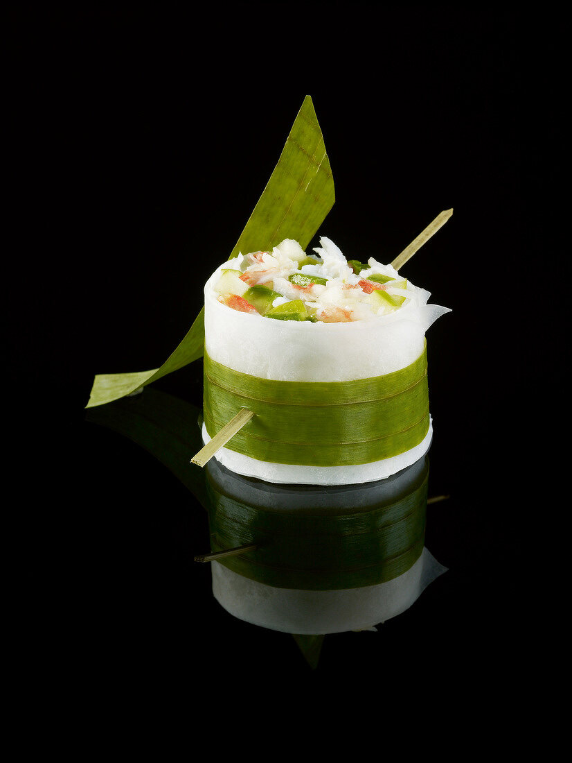 Crab,avocado and green apple black radish makis on a black background