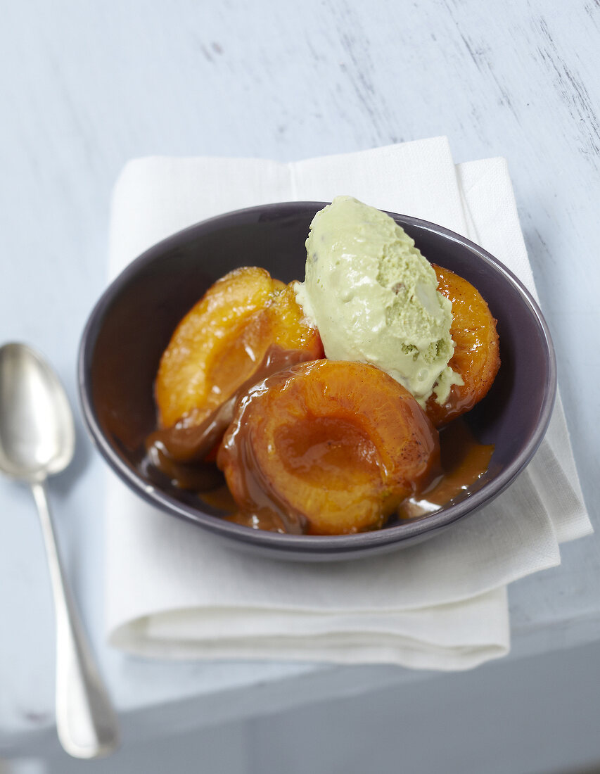 Roasted apricots in toffee sauce with pistachio ice cream