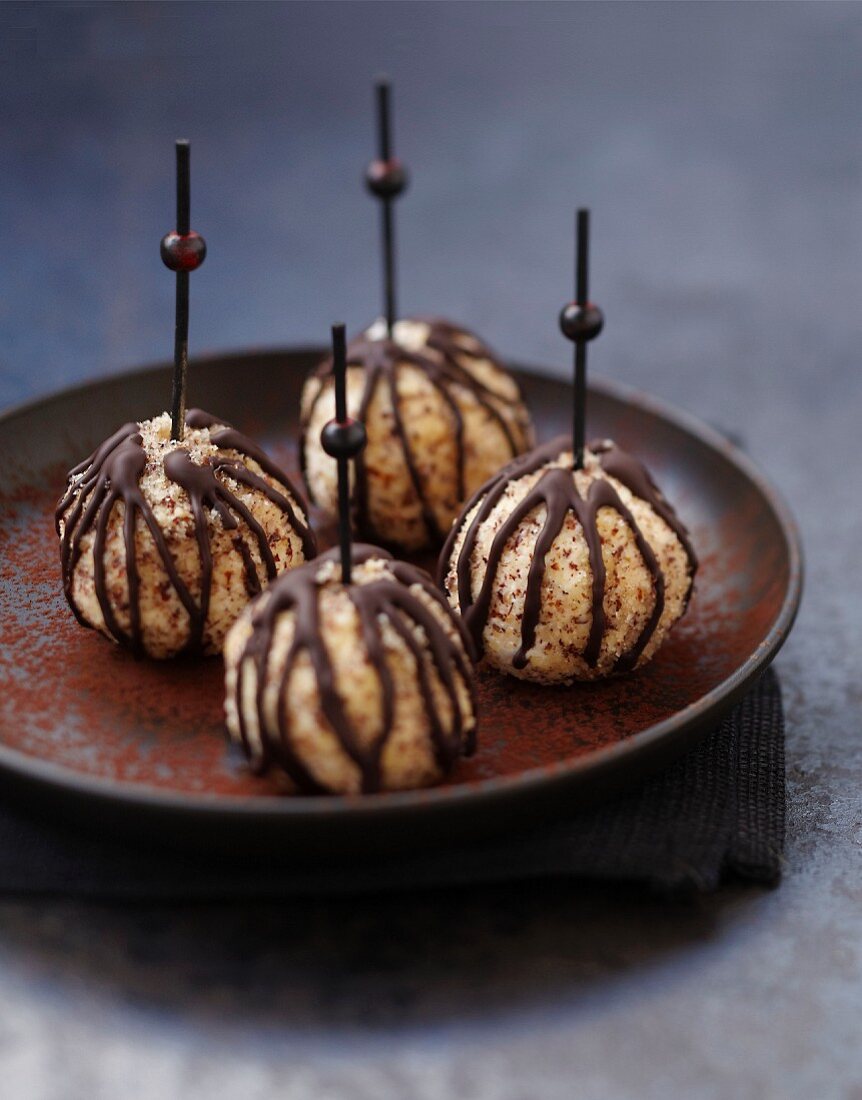 Goat's cheese pops coated in hazelnuts and chocolate sauce