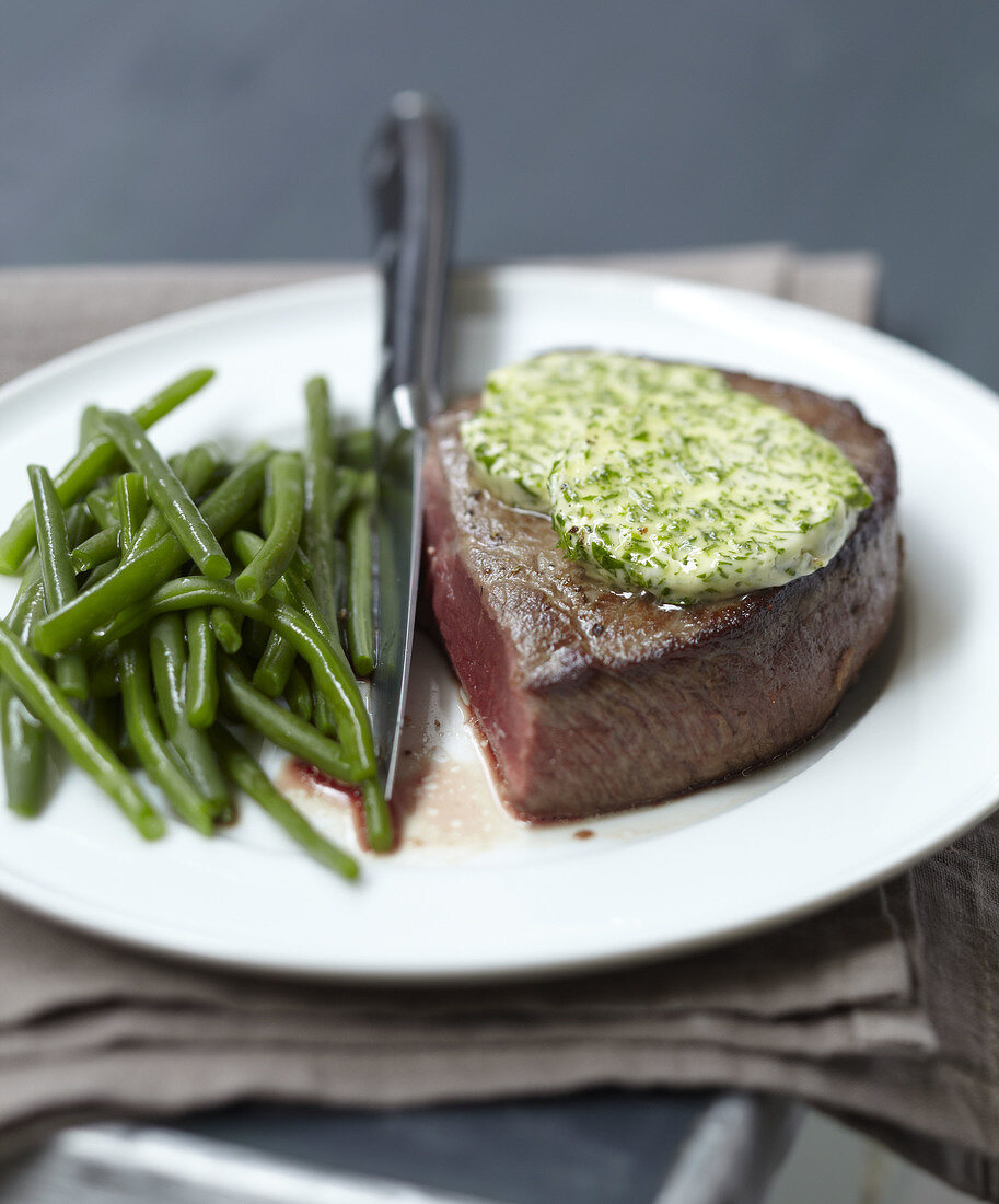 Rare steak with parsley butter and green beans