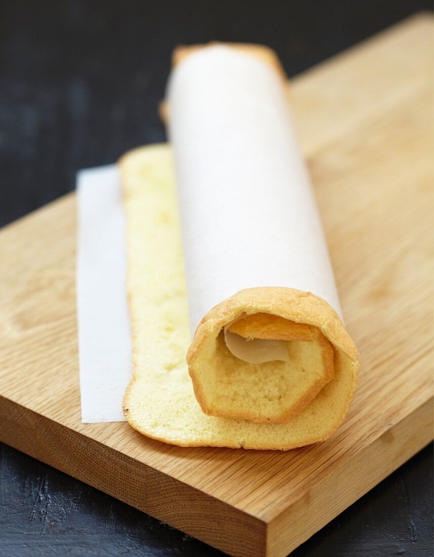 Rolling the sponge cake with the wax paper