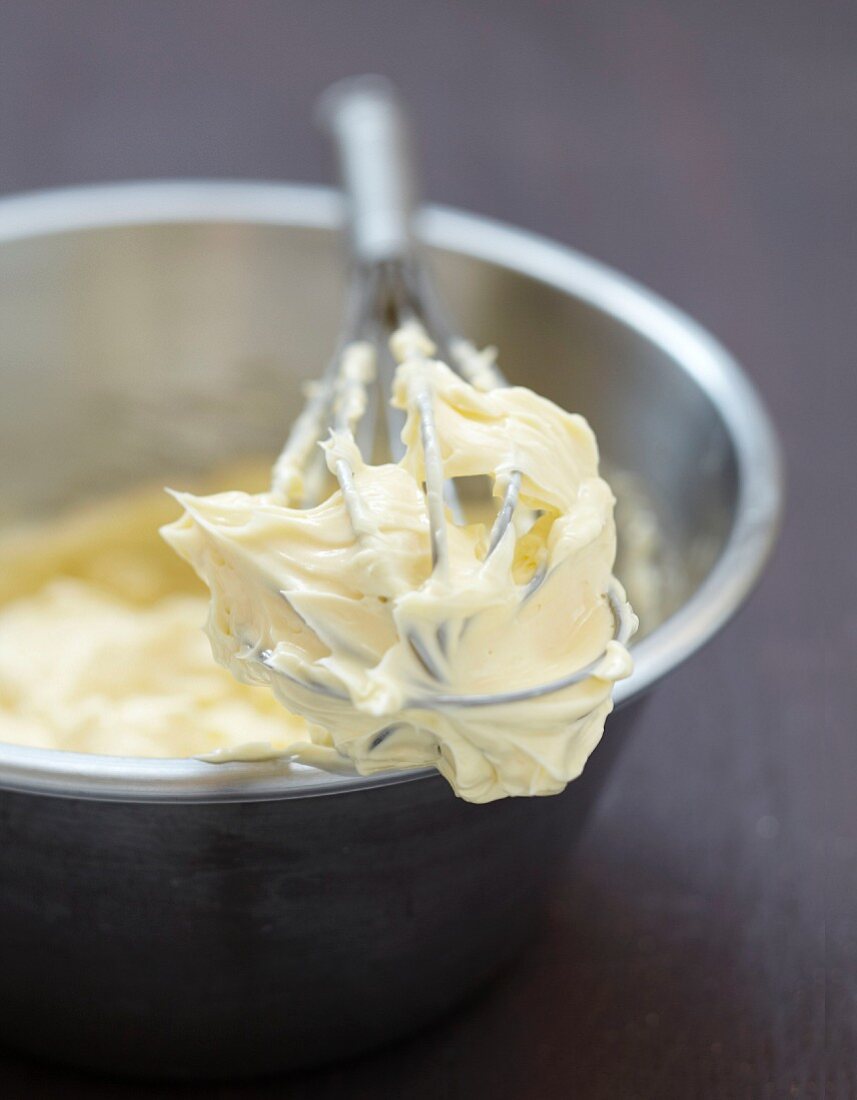 Preparing the butter cream :mixing together the sabayon and the cubes of butter