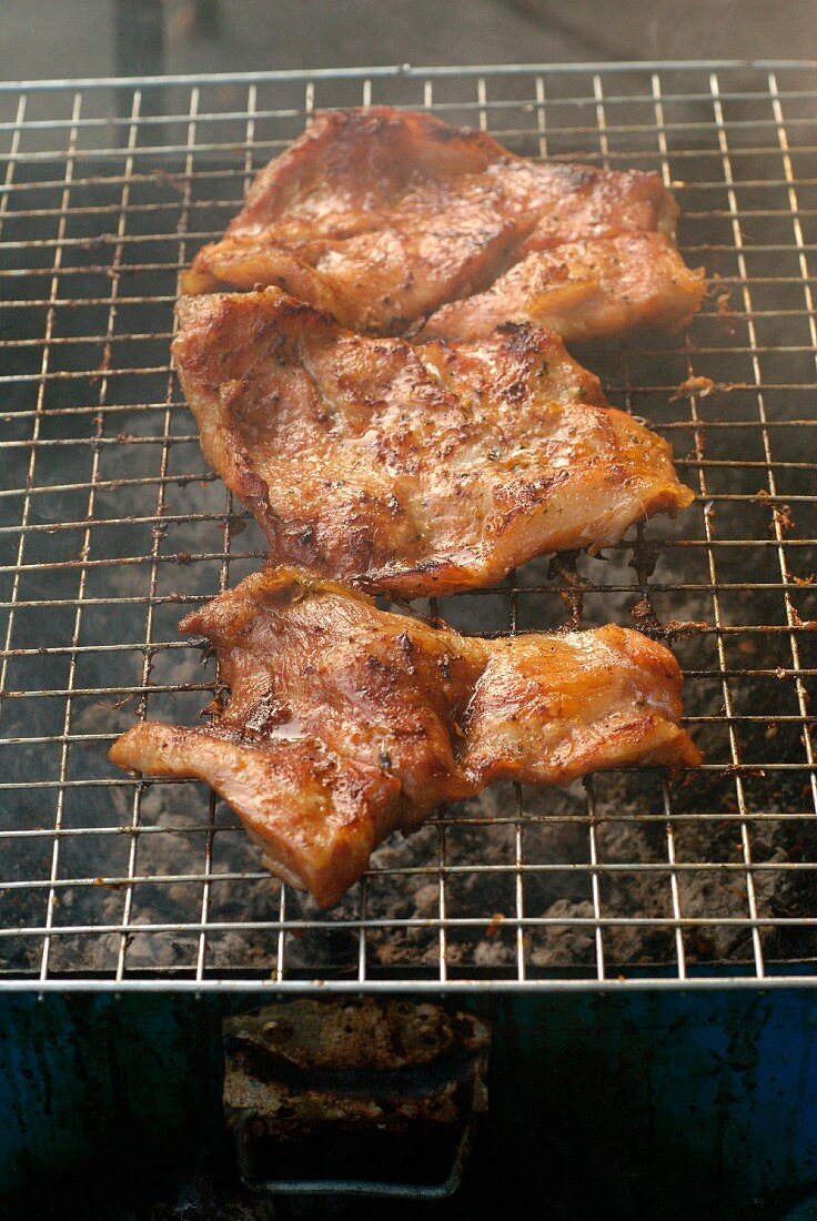 Grilling marinated pork in the street