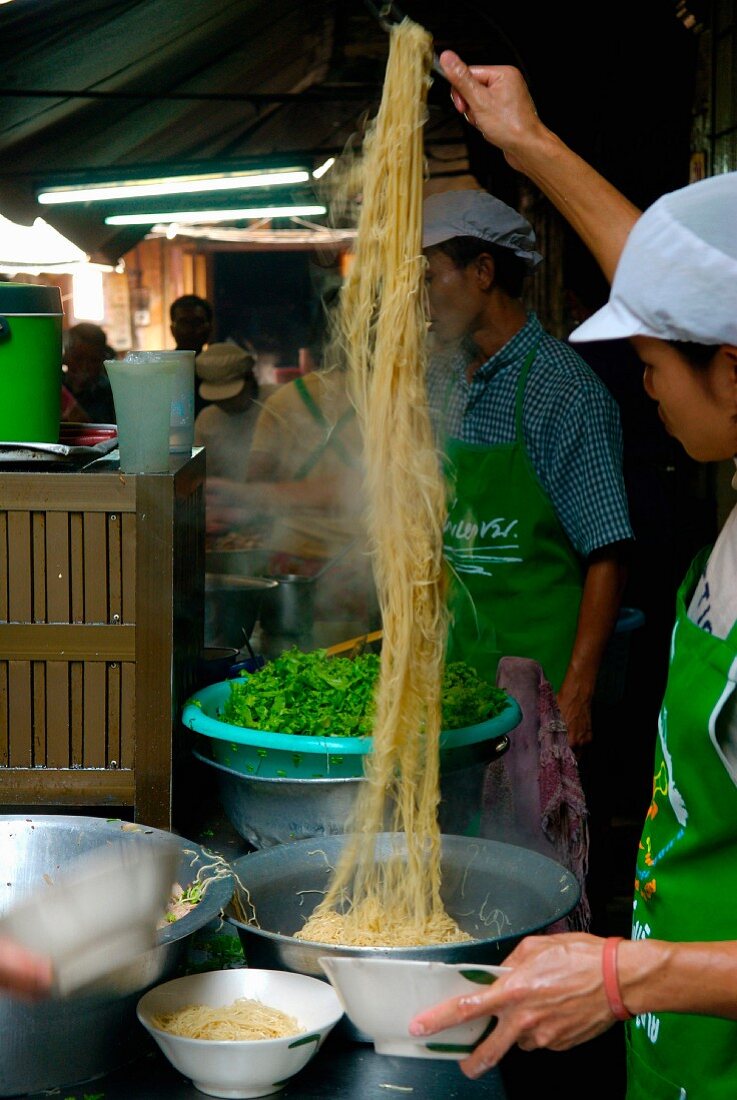 Preparing noodles in the street