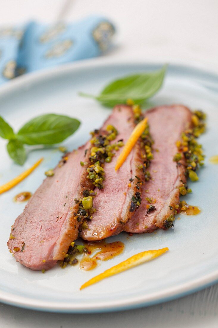 Duck magret in pistachio crust with orange coulis