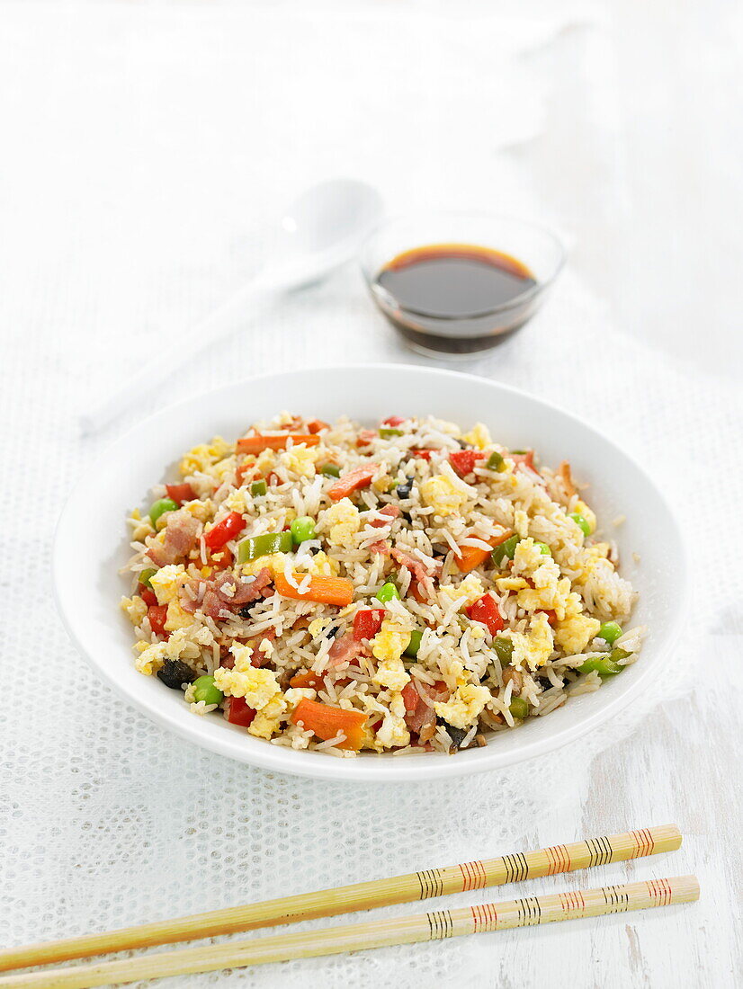 Rice sauteed with bacon, shrimps, peas, carrots and eggs