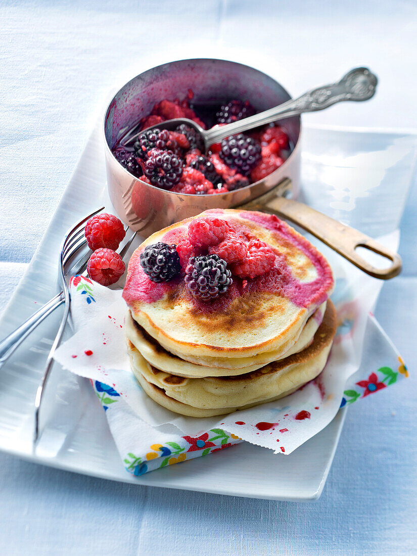 Pancakes with stewed blackcurrants and raspberries