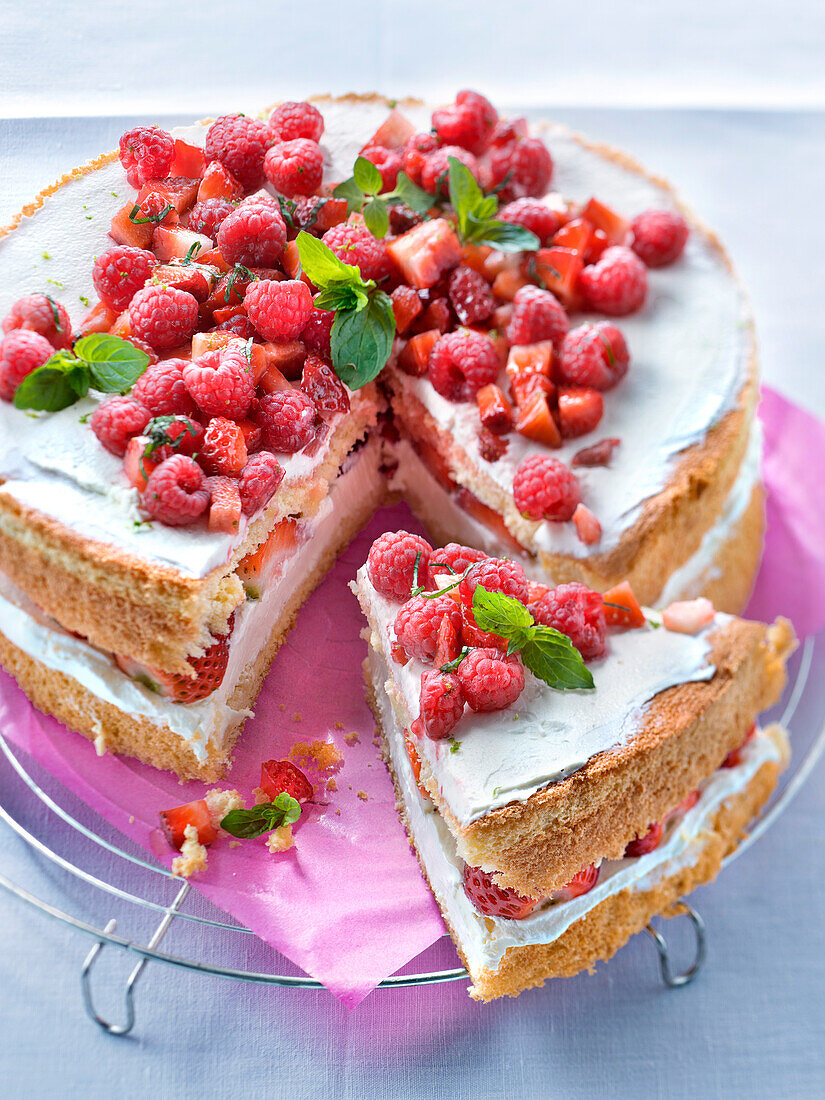 Lyered sponge cake with lime cream filling with fresh strawberries and raspberries