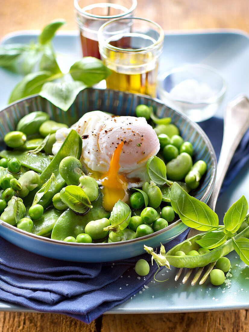Pea,broad bean and swwet pea salad with a poached egg