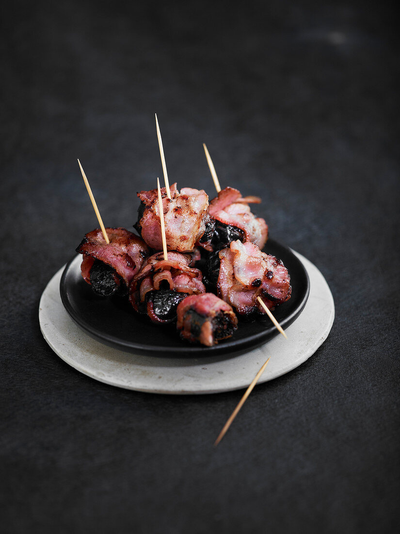 Prunes wrapped in smoked bacon
