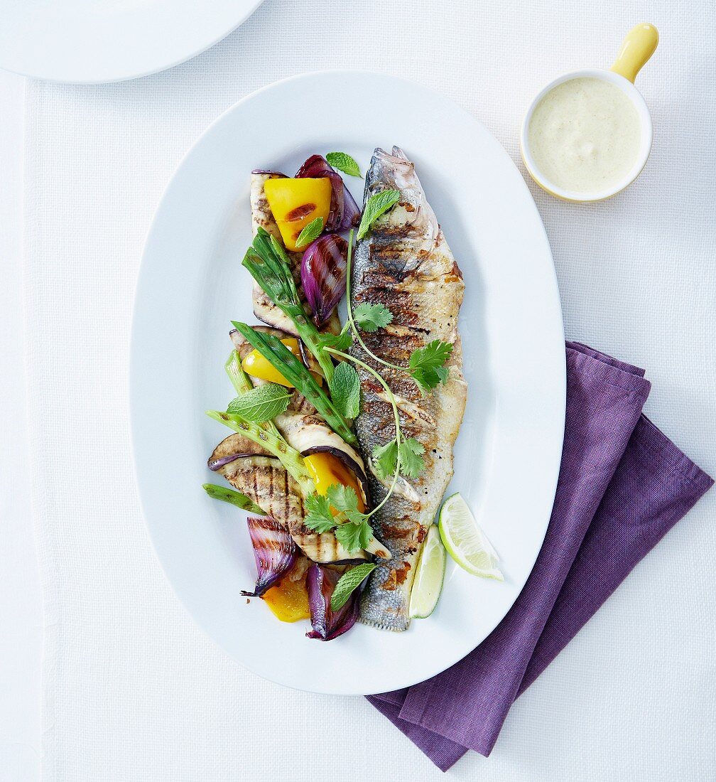 Grilled bass with lime,fresh herbs,eggplant,pepper and grilled onions