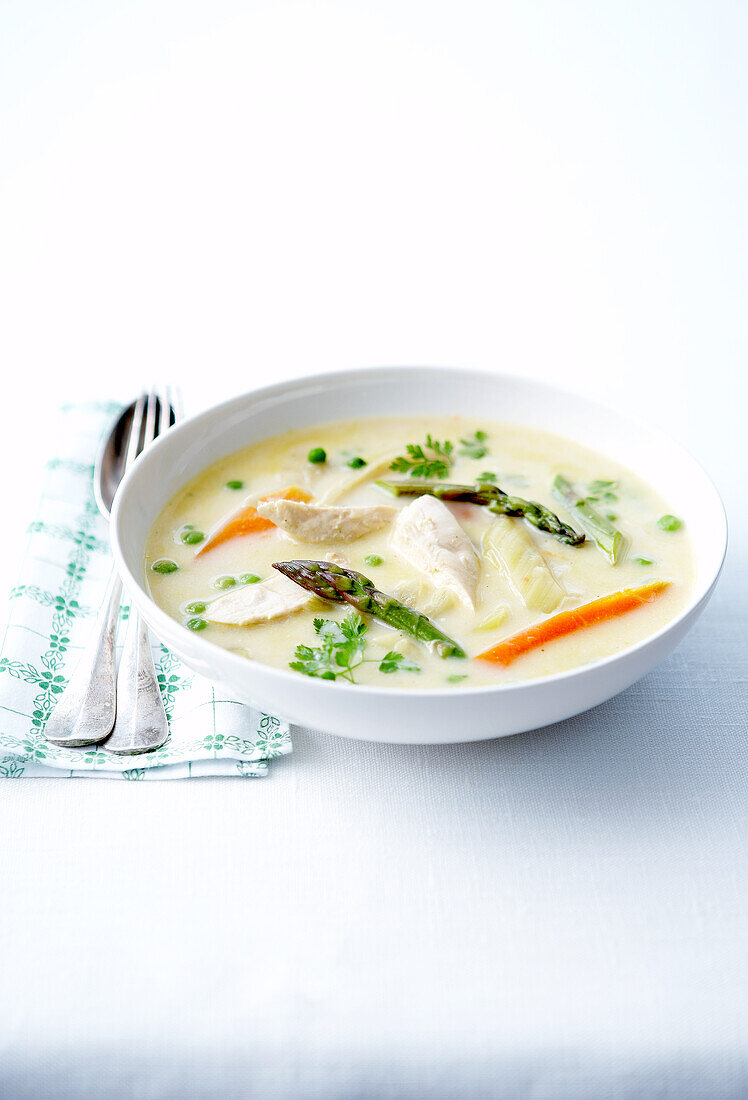 Cream of potato soup with chicken and spring vegetables