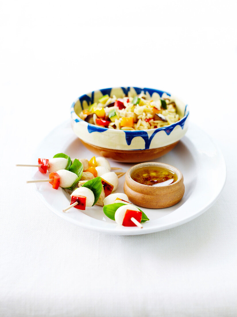 Mozzarella ball, chicken and bell pepper brochettes, mixed rice salad